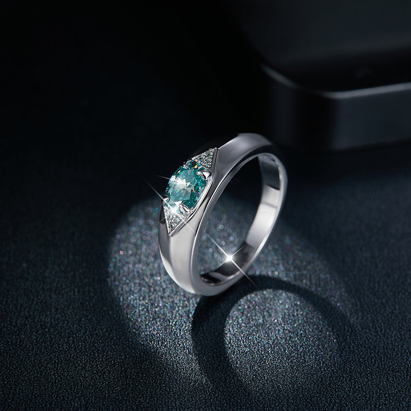 CARISSIE round moissanite solitaire ring, angled side view displaying the teal center stone and triangular diamond accents on a wide silver band
