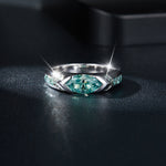 CARISSIE marquise moissanite bezel engagement ring, low angle close-up capturing light reflection on the polished metal surface