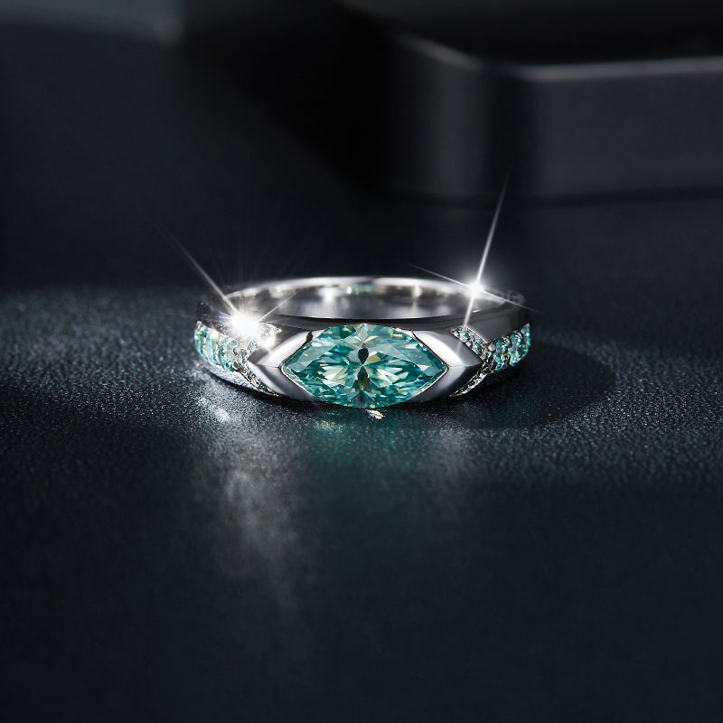 CARISSIE marquise moissanite bezel engagement ring, low angle close-up capturing light reflection on the polished metal surface