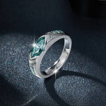 CARISSIE marquise moissanite bezel engagement ring, lifestyle shot on dark textured background with dramatic lighting sparkle