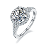 CARISSIE round moissanite halo engagement ring, angled view highlighting split shank shoulders and pavé accents