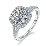 CARISSIE round moissanite halo engagement ring, angled view highlighting split-shank band with pavé stones and four-prong setting