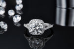 CARISSIE round moissanite halo engagement ring, front view on reflective surface displaying clear mirror image and full halo circumference