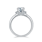 CARISSIE round moissanite solitaire ring, front profile showing tapered band and side accent stones under the head
