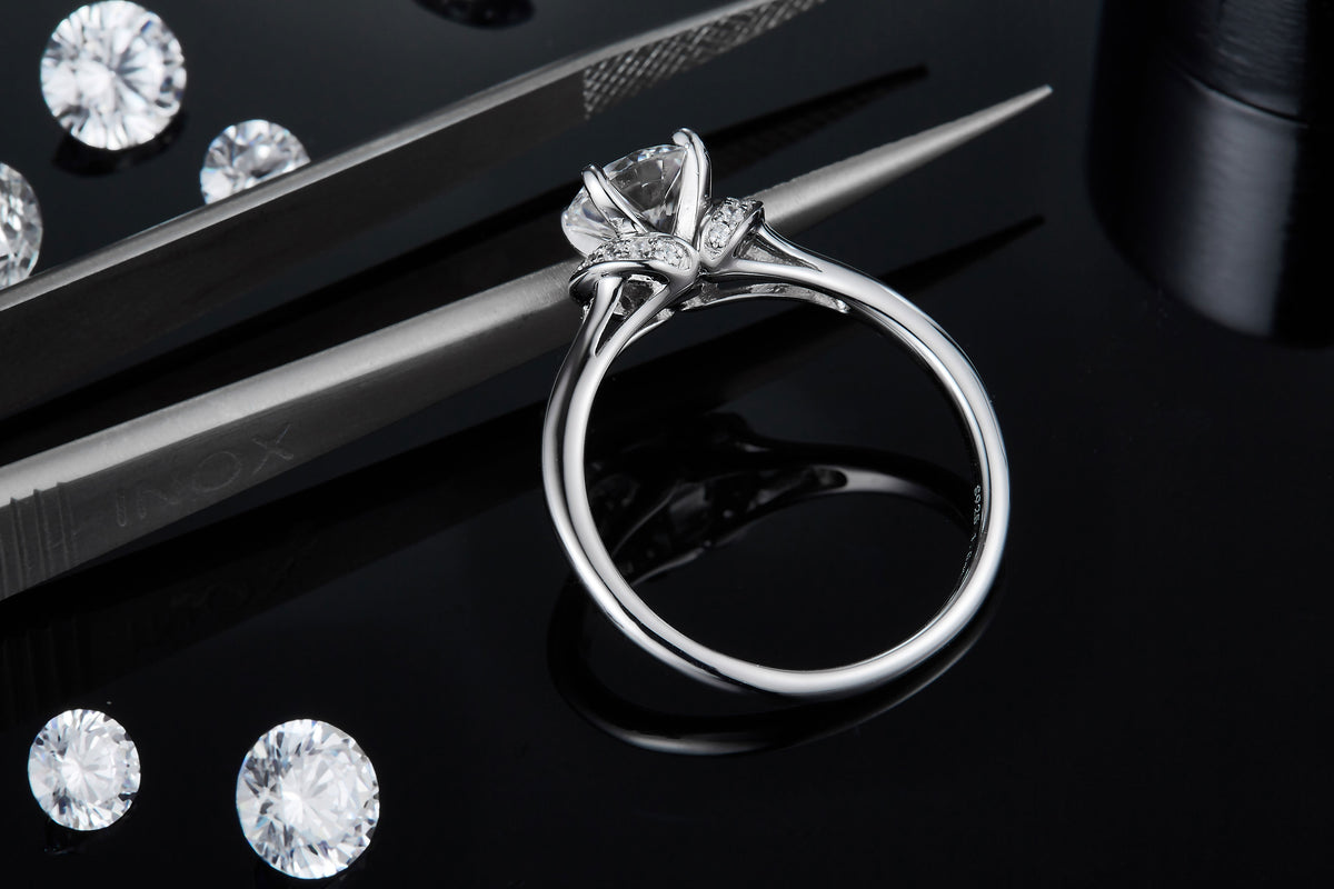 CARISSIE round moissanite solitaire ring, diagonal perspective revealing interior band stamping and metal craftsmanship