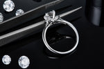CARISSIE round moissanite solitaire ring, diagonal perspective revealing interior band stamping and metal craftsmanship