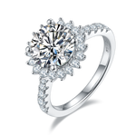 CARISSIE round moissanite halo engagement ring, angled view highlighting brilliant center stone and pavé band details