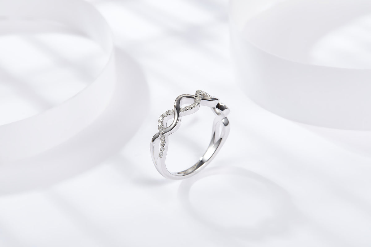 CARISSIE round moissanite pavé wedding band, elevated angle showcasing the delicate height of the wavy design against a clean background.