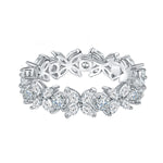 CARISSIE Round Moissanite Prong Eternity Band III, angled view showing floral motif with round and marquise stones plus openwork gallery