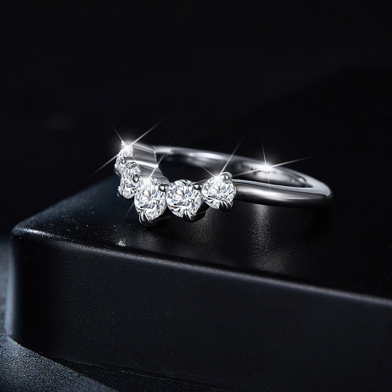 CARISSIE graduated moissanite ring, dramatic side profile on a black box emphasizing the sparkle and high-polish finish