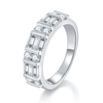CARISSIE moissanite eternity band, angled view showing alternating baguette and round stones in a wide silver-tone channel setting