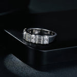 CARISSIE moissanite eternity band, close-up resting on black display box revealing S925 hallmark inside the sterling silver band