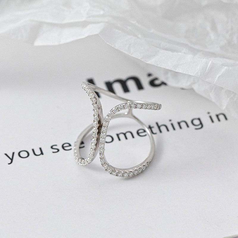 CARISSIE pavé statement ring, white metal variant displayed at angle to show open-work structure