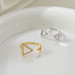 CARISSIE round moissanite pavé engagement ring, diagonal composition of gold and silver styles highlighting the asymmetrical design