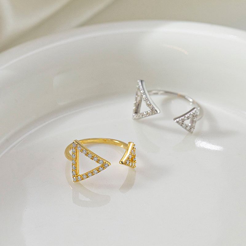 CARISSIE round moissanite pavé engagement ring, diagonal composition of gold and silver styles highlighting the asymmetrical design