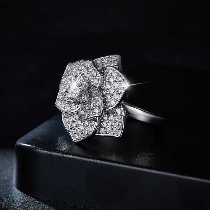 CARISSIE statement flower ring, resting on a black display box to showcase the contrast between the white gold and gems