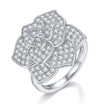 CARISSIE moissanite pavé flower ring, angled view showing layered petals and center stone on polished silver band