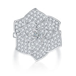 CARISSIE floral statement ring, top-down view highlighting the full diamond-encrusted bloom and central round gemstone