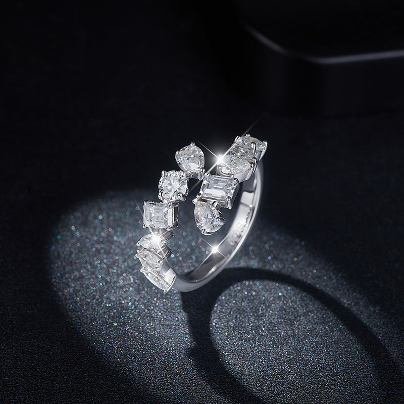 CARISSIE mixed-cut moissanite bypass ring, artistic spotlight view revealing the multi-dimensional texture of the setting