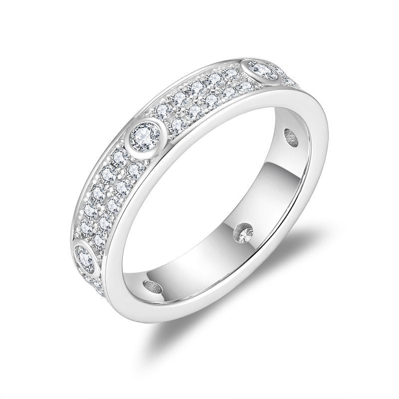CARISSIE round moissanite eternity band, close-up side profile highlighting polished silver-tone metal and stone setting
