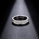 CARISSIE round moissanite eternity band under spotlight, interior view revealing S925 hallmark and inner gallery details