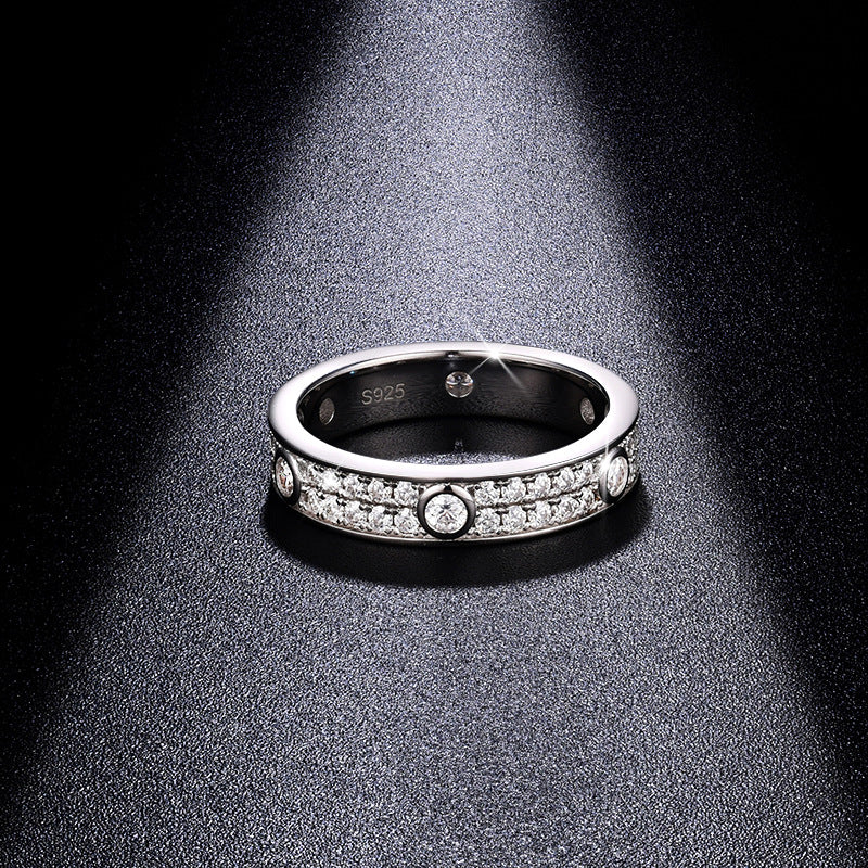 CARISSIE round moissanite eternity band under spotlight, interior view revealing S925 hallmark and inner gallery details