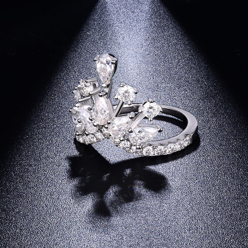 CARISSIE round moissanite pavé engagement ring angled close-up, revealing the depth of the multi-level pear and round stones