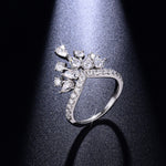 CARISSIE round moissanite pavé engagement ring top-down view under spotlight, emphasizing the brilliance of the pavé band