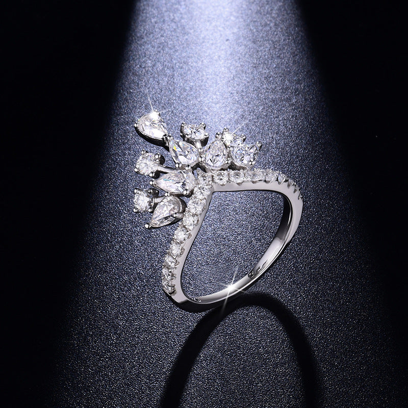 CARISSIE round moissanite pavé engagement ring top-down view under spotlight, emphasizing the brilliance of the pavé band