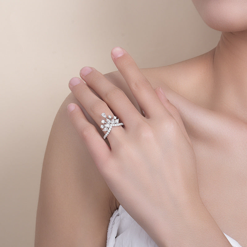 CARISSIE round moissanite pavé engagement ring on model hand, showcasing the organic floral cluster design and split shank band