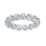 CARISSIE heart moissanite eternity band, angled view showing openwork gallery with heart-shaped cutouts in silver-tone metal