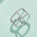 CARISSIE round moissanite pavé statement ring, lifestyle shot on a mint green surface casting a shadow to emphasize the architectural structure