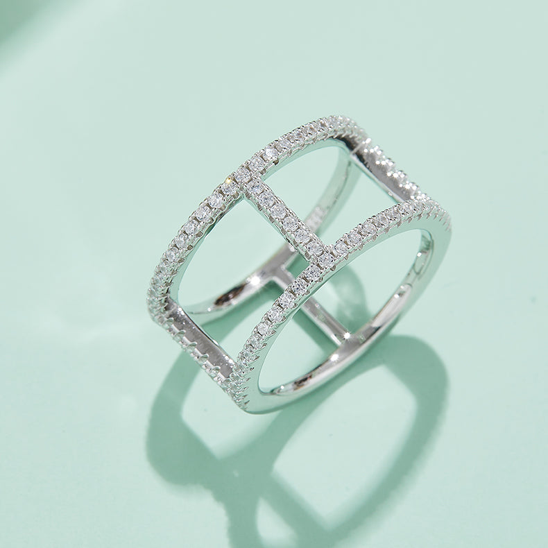 CARISSIE round moissanite pavé statement ring, lifestyle shot on a mint green surface casting a shadow to emphasize the architectural structure