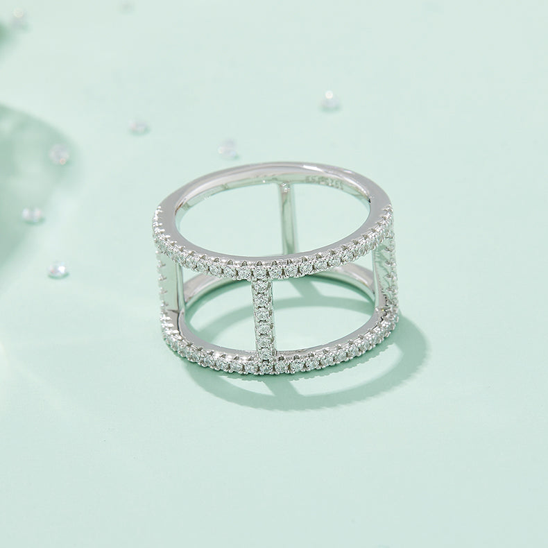 CARISSIE round moissanite pavé statement ring, styled product photo on a pastel background surrounded by loose stones for context