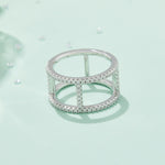 CARISSIE round moissanite pavé statement ring, styled product photo on a pastel background surrounded by loose stones for context