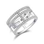 CARISSIE round moissanite pavé statement ring, angled view showing geometric open-work design and three parallel stone bands