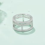 CARISSIE round moissanite pavé statement ring, front view surrounded by loose stones to showcase brilliance and sparkle