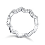 CARISSIE round moissanite pavé ring, front view displaying the continuous zigzag band with sparkling stones on the upper ridge