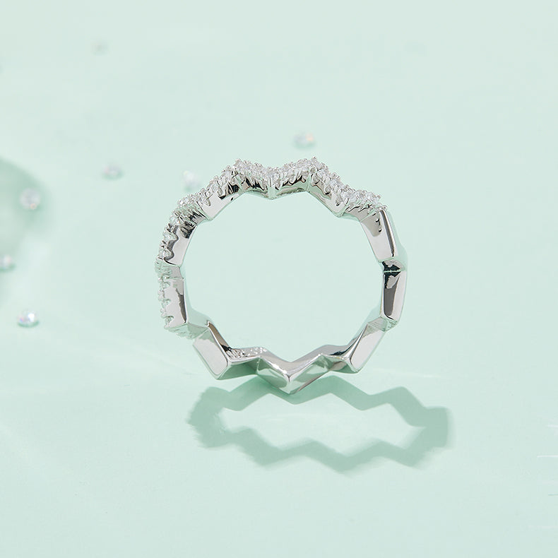 CARISSIE round moissanite pavé ring, lifestyle shot on a mint green background casting a distinct zigzag shadow