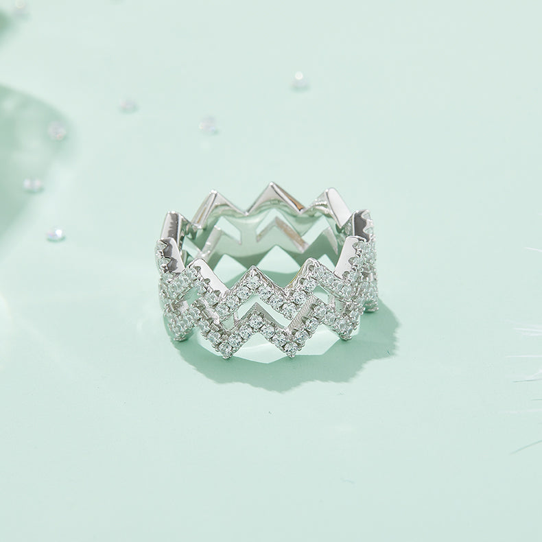CARISSIE round moissanite pavé statement ring, lifestyle shot on mint green surface displaying the full width of the band