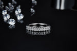 CARISSIE round moissanite eternity band, horizontal perspective showcasing full circumference of diamonds with reflection below