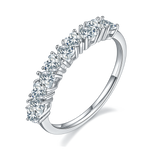 CARISSIE round moissanite eternity band, top-down angle emphasizing the rhythmic cage-like structure of the prongs