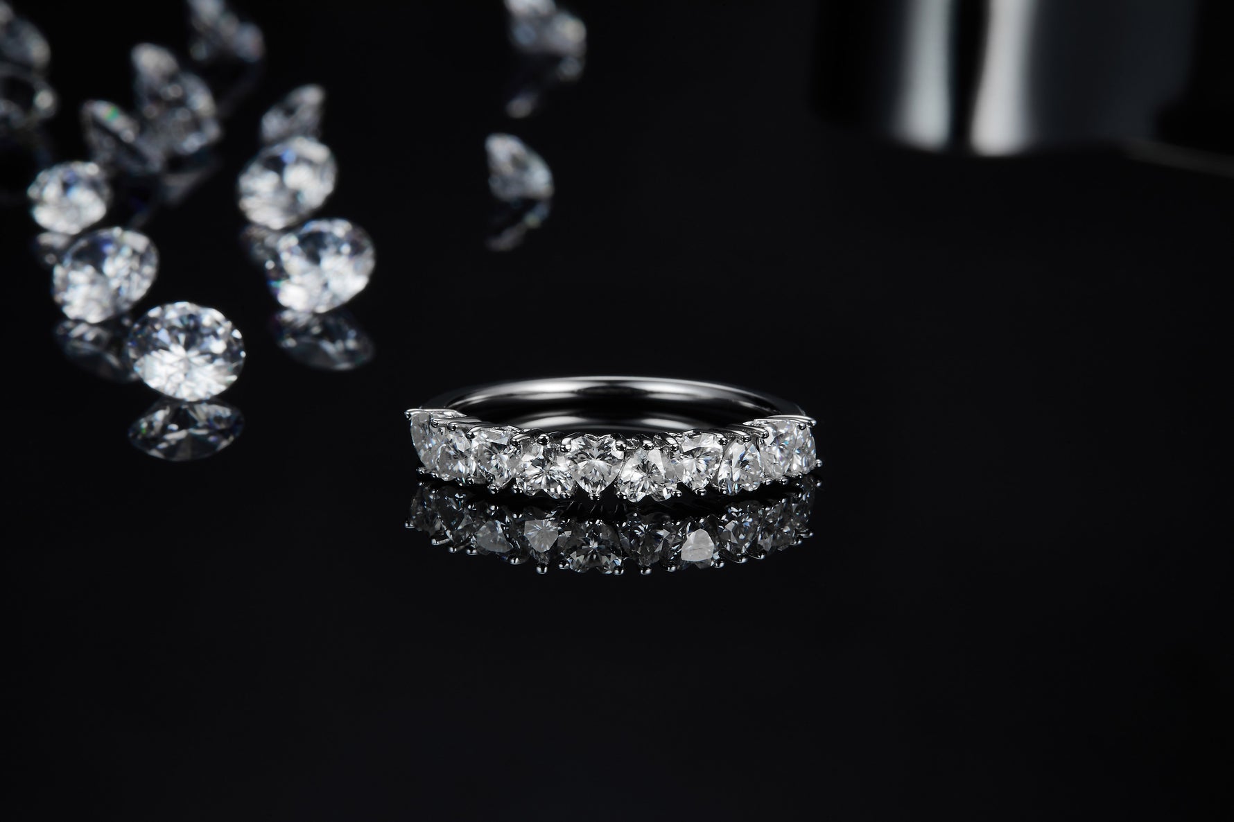 CARISSIE round moissanite eternity band, close-up with tweezers revealing detailed craftsmanship and inner gallery