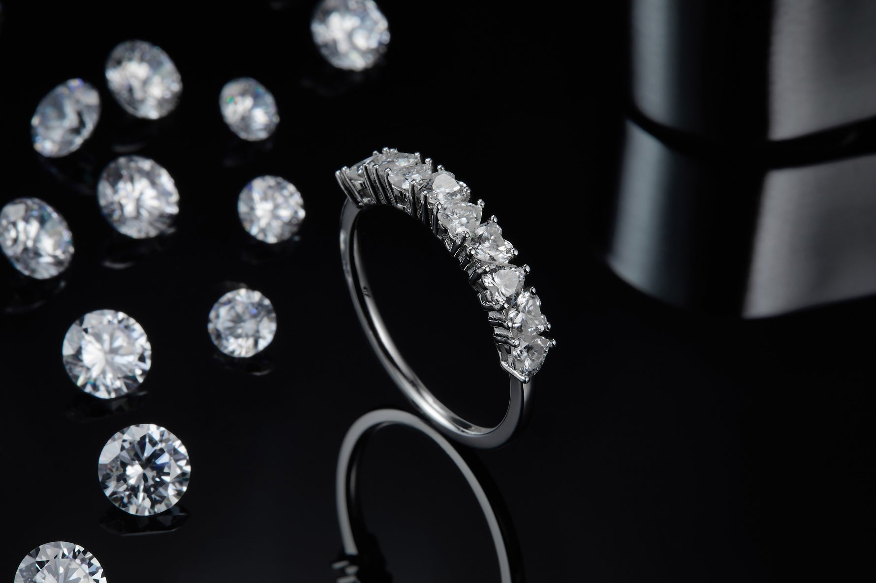 CARISSIE round moissanite eternity band, side perspective showing polished silver metal shank and gemstone alignment