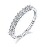 CARISSIE Princess Moissanite Eternity Band, angled view highlighting the high-polish silver-tone shank and four-prong setting details.