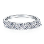 CARISSIE round moissanite eternity band, front perspective showing the continuous row of brilliant-cut stones in a prong setting.