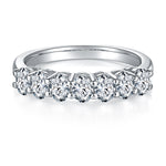 CARISSIE oval moissanite eternity band, front-facing close-up revealing detailed stone facets and symmetrical four-prong settings along the curved band