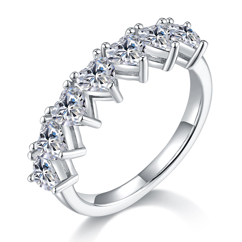 CARISSIE heart moissanite eternity band, angled view highlighting the vertical prong settings and polished silver-tone shank.