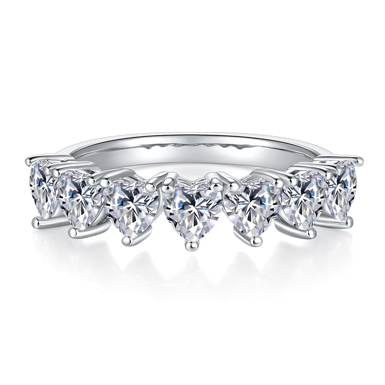 CARISSIE heart moissanite eternity band, front profile showing a continuous row of downward-pointing heart stones in white metal.