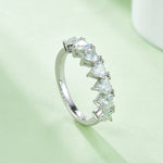 CARISSIE heart moissanite eternity band, diagonal shot displaying the smooth curve of the ring band and secure stone placement.